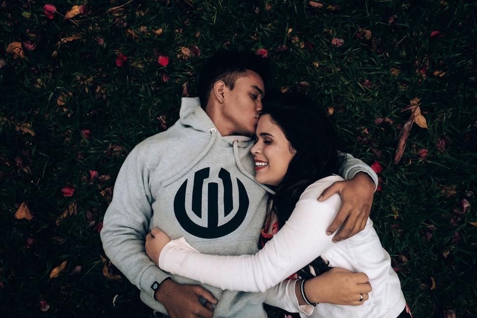 Free Image of Man and Woman Hugging in the Grass 