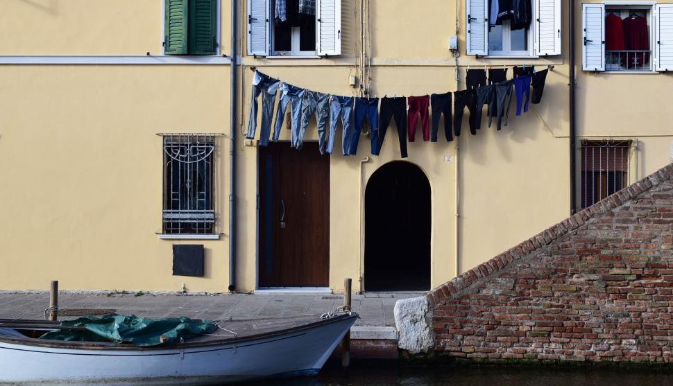 Free Image of Boat Docked by Building in Water 