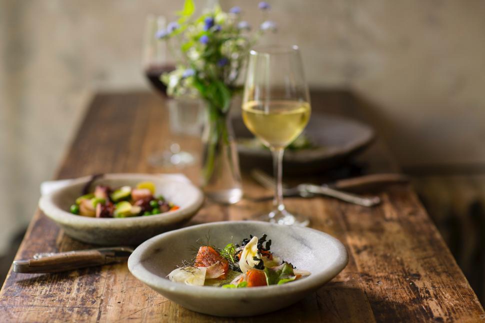 Free Image of Wooden Table Set With Plates of Food and Glass of Wine 