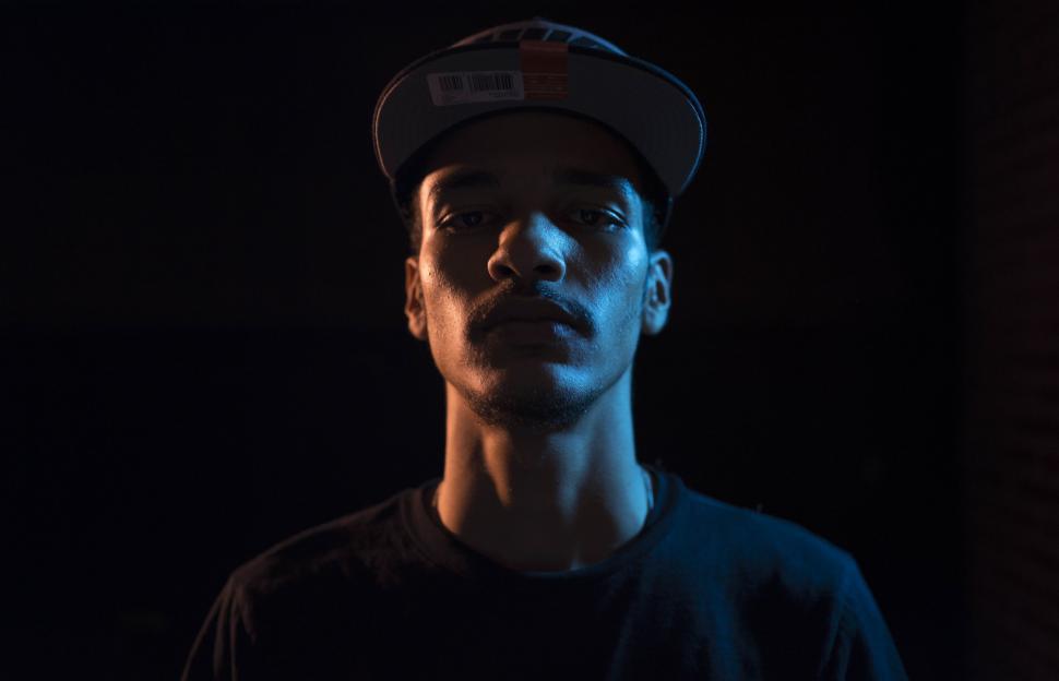 Free Image of Man Standing in the Dark With Hat 