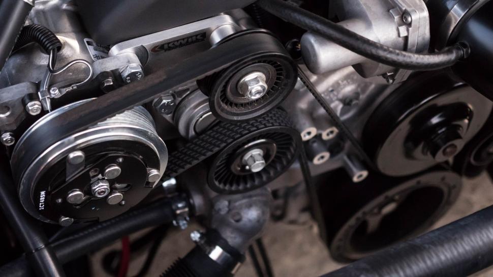 Free Image of Close Up of Car Engine With Connected Hose 