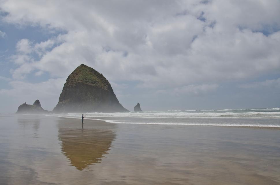 Free Image of Person Standing on Beach Next to Ocean 