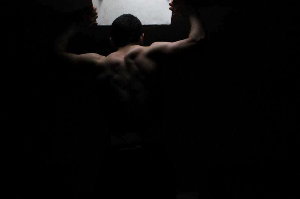 Free Image of Man and Woman Standing in a Dark Room 