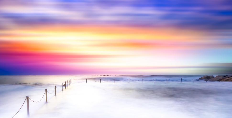 Free Image of Beach Painting With Fence in Foreground 