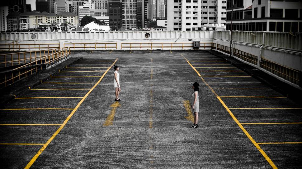 Free Image of People Walking Across Parking Lot 