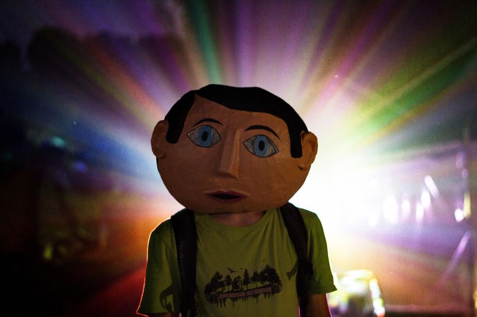 Free Image of Person With Backpack Standing in Front of Light 