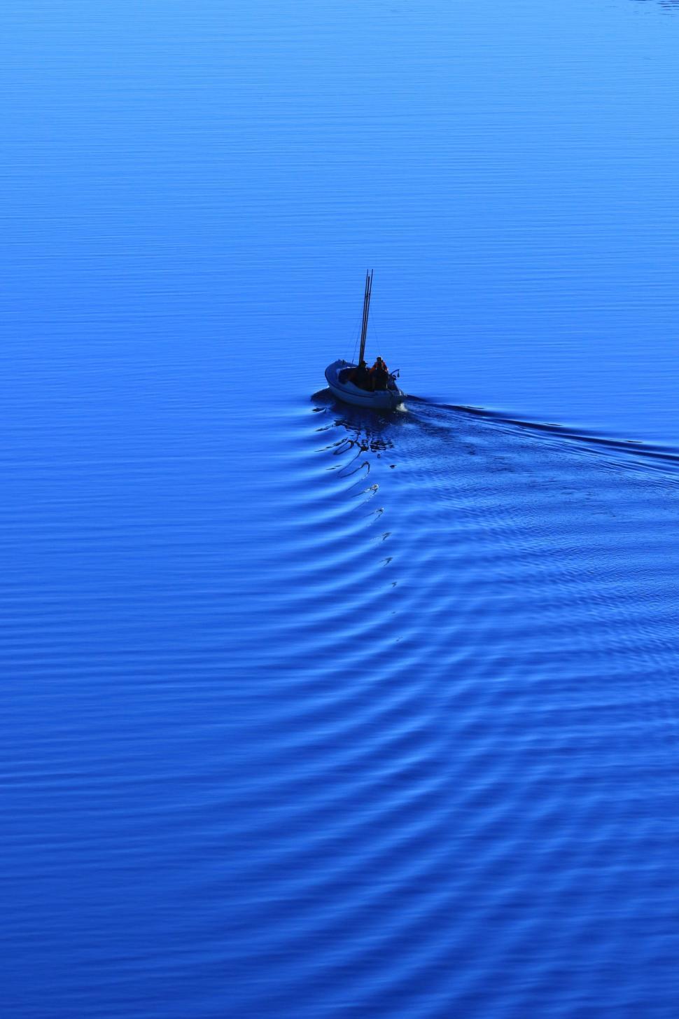 Free Image of Small Boat Floating on Large Body of Water 
