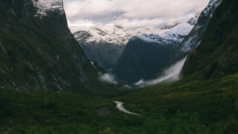 Free Image of A View of a Mountain With a Road Going Through It 