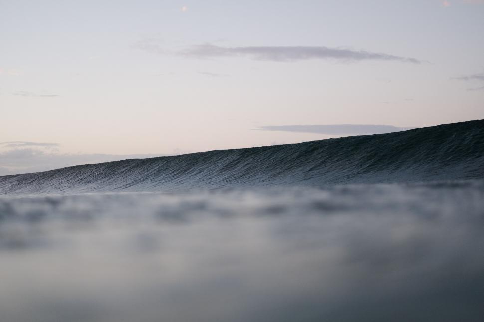 Free Image of Man Riding Wave on Surfboard 