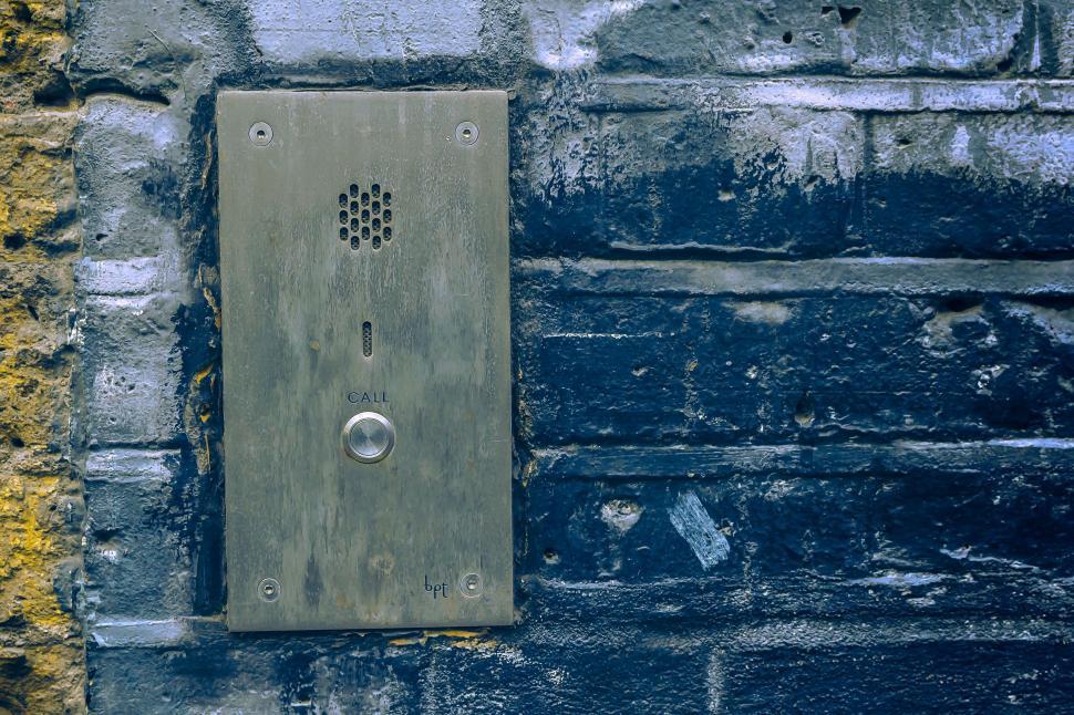 Free Image of Metal Device Mounted to Brick Wall 