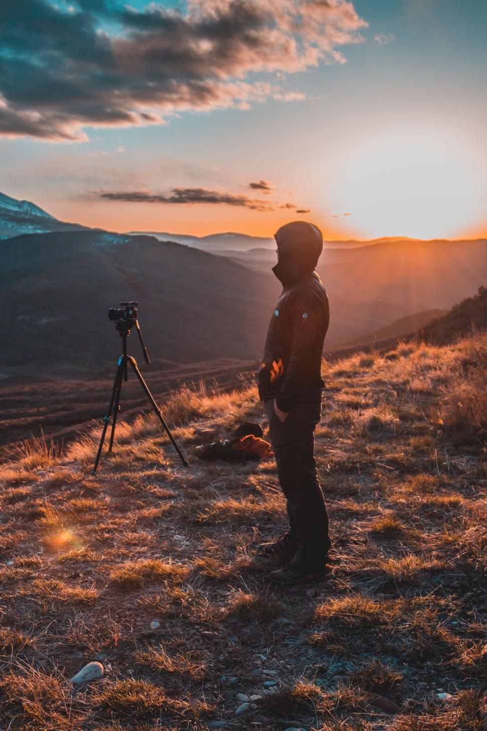 Free Image of Man Standing on Grass-Covered Hillside 