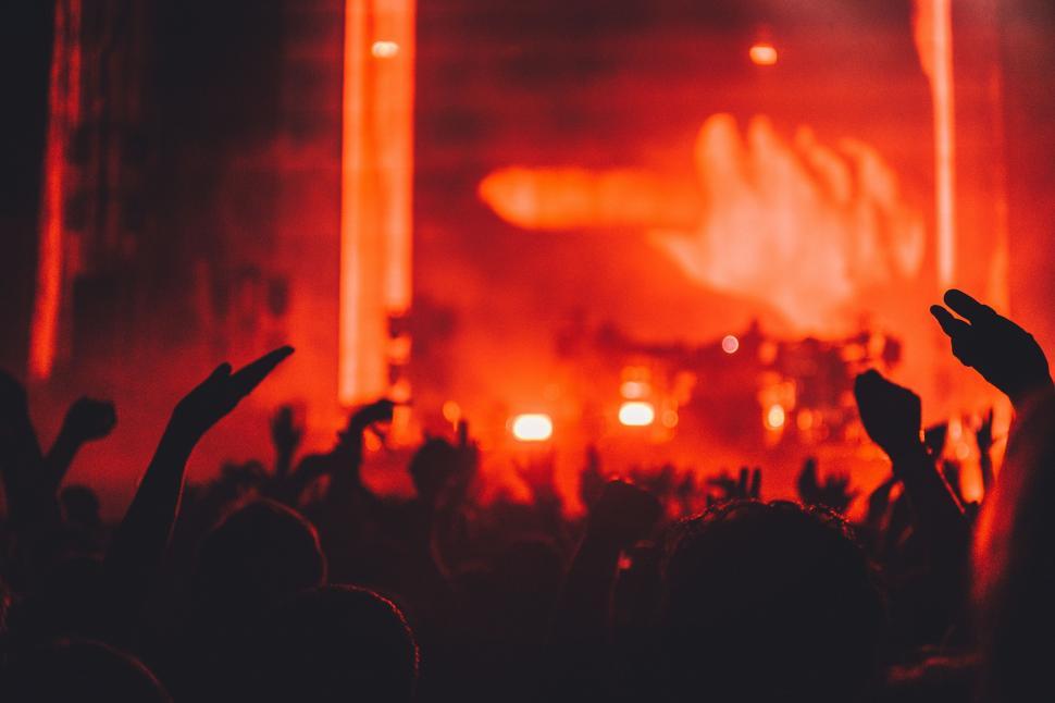 Free Image of Energetic Crowd With Hands Raised at Concert 