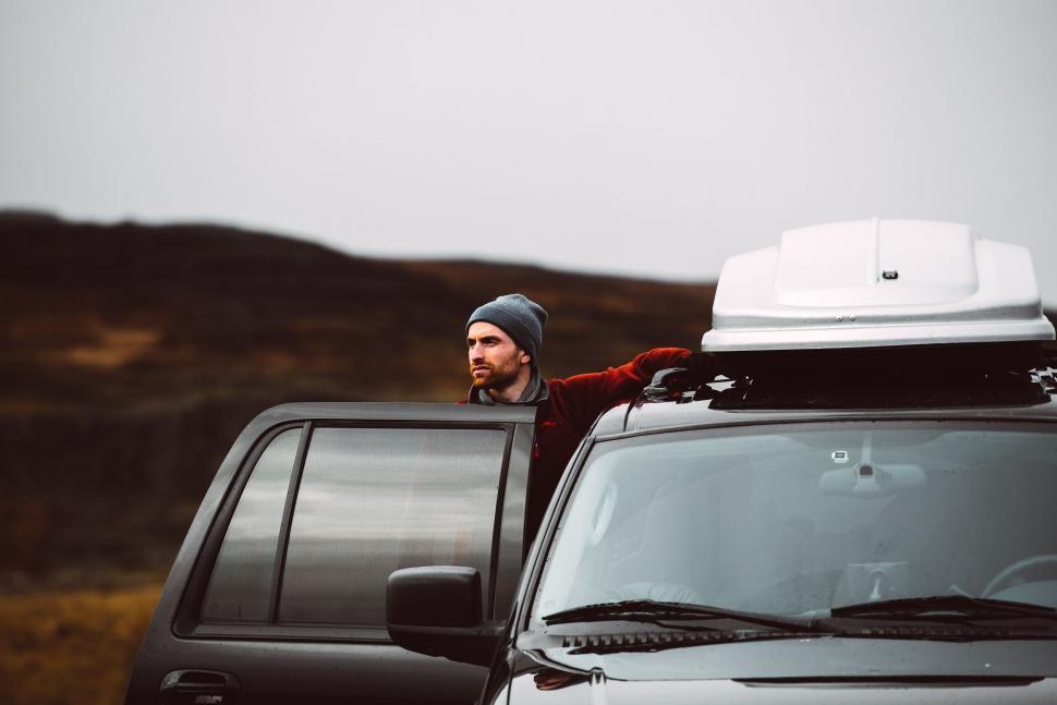 Free Image of Man Standing Next to Black Truck 