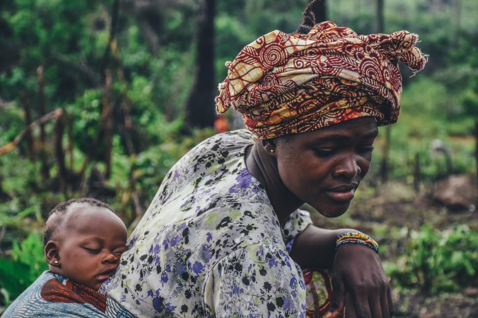 Free Image of Woman Holding a Baby in Her Arms 