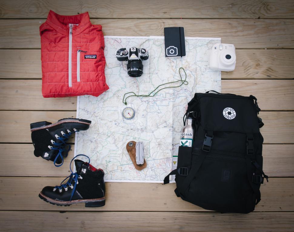 Free Image of Backpack Contents Arranged on Map 
