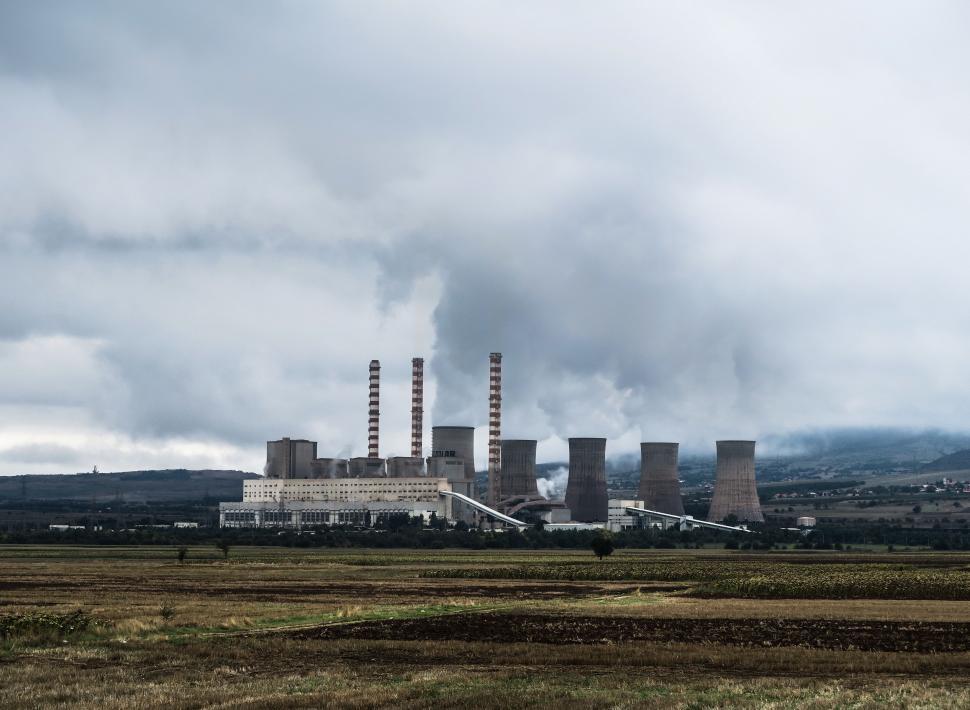 Free Image of Industrial Factory With Smoke Stacks in the Background 