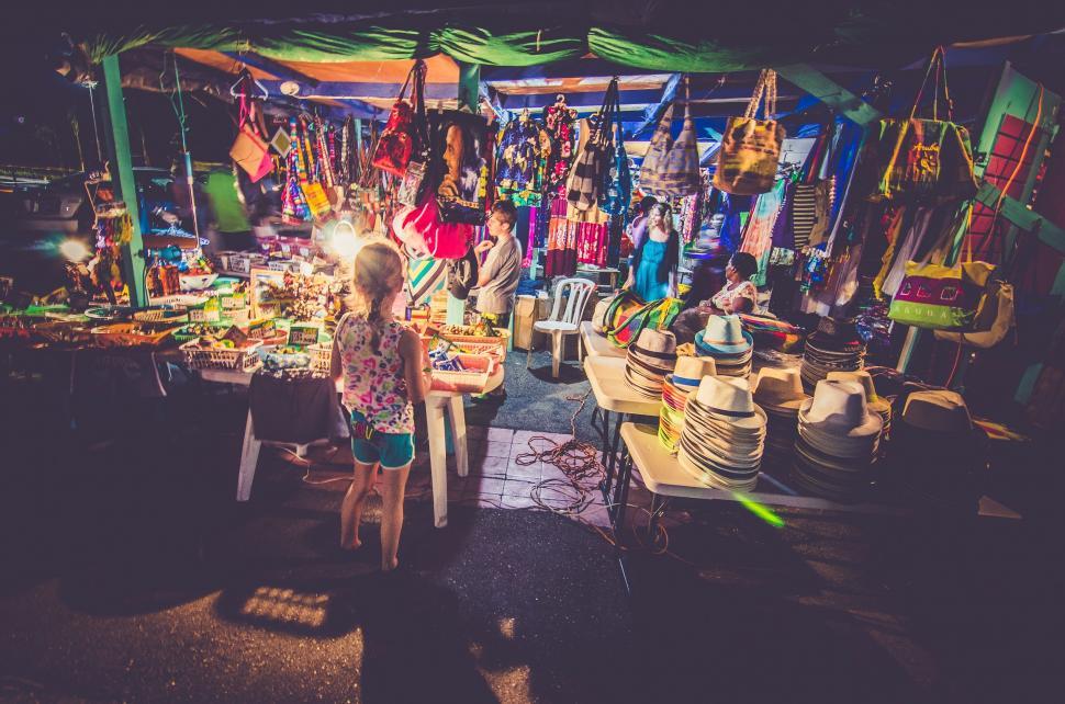 Free Image of Woman Standing in Front of Table Filled With Items 