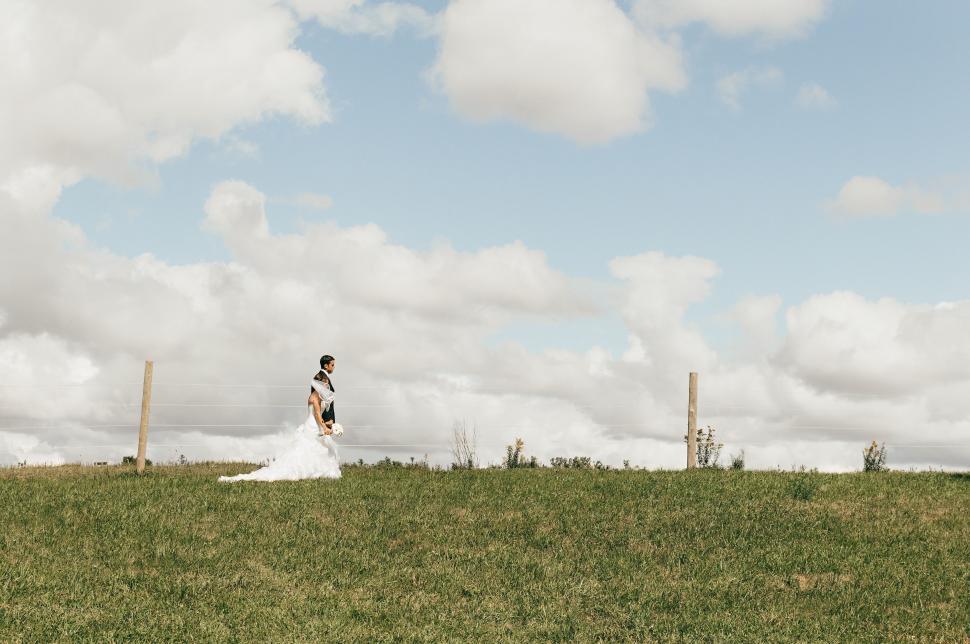 Free Image of Man Standing on Top of Lush Green Field 