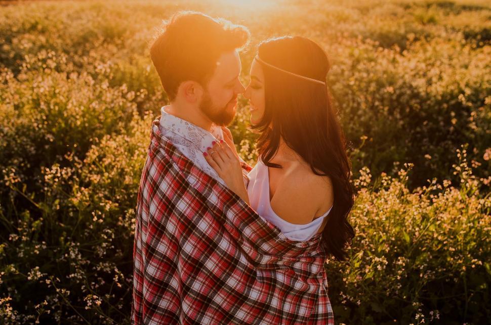 Free Image of Man and Woman Standing in a Field of Flowers 