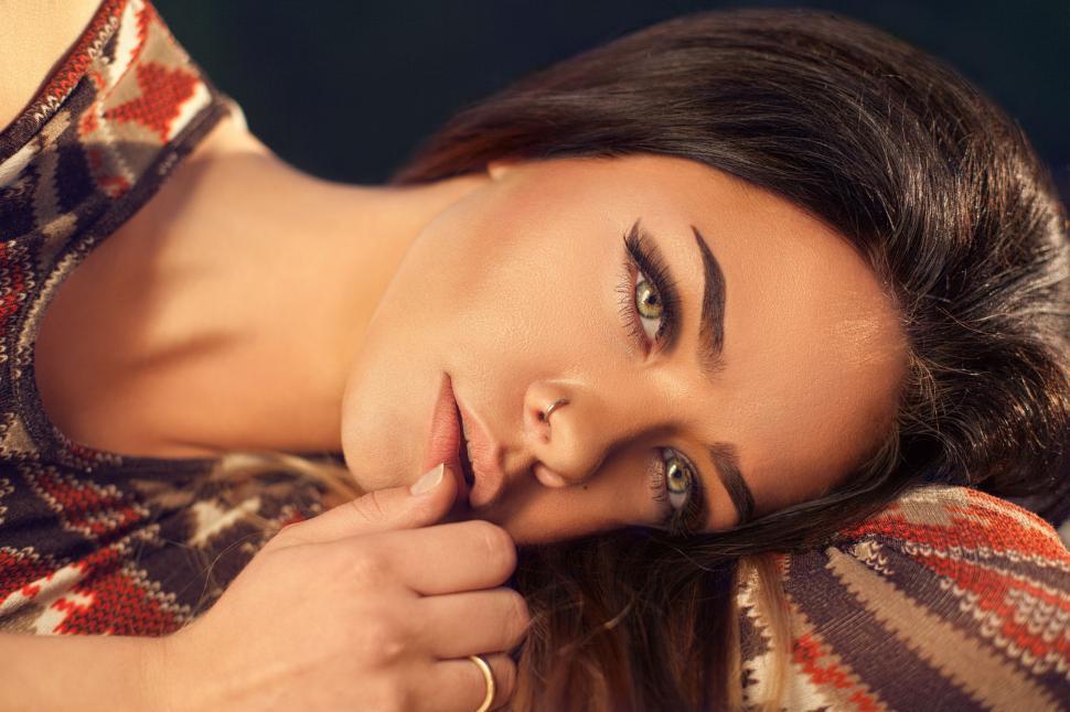 Free Image of Woman Laying on Top of a Couch Next to a Man 