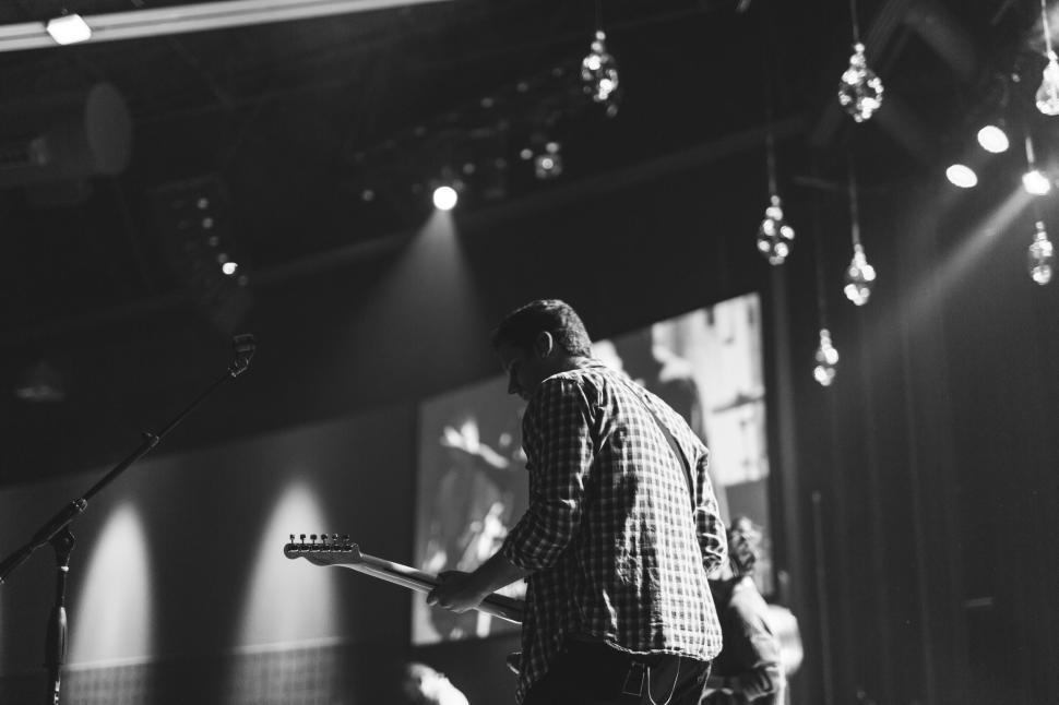 Free Image of Man Playing Guitar in Black and White 