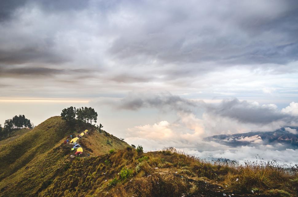 Free Image of Group of People Sitting on Top of a Hill 