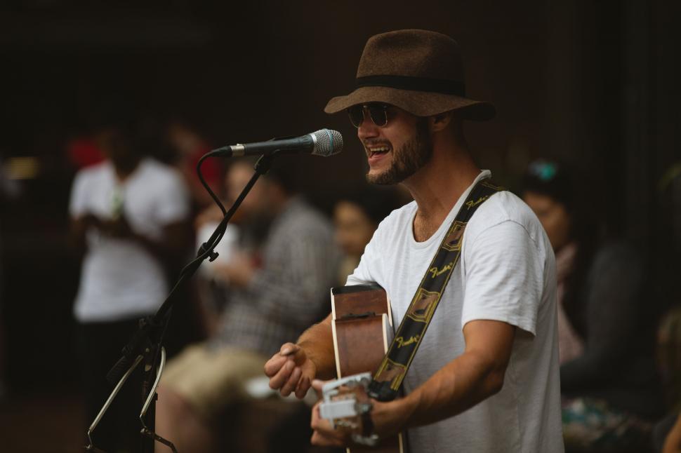 Free Image of Man Playing Guitar in Front of Microphone 