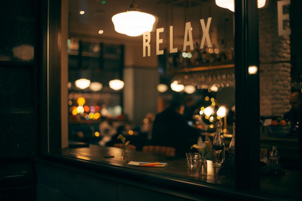 Free Image of Peoples Reflection in Restaurant Window 