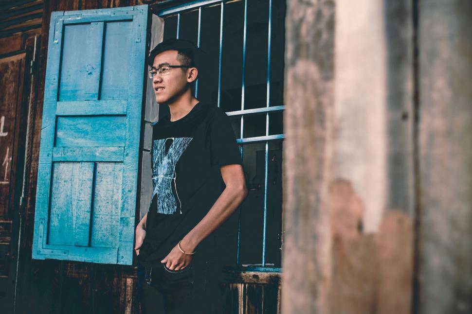 Free Image of Man Standing in Front of Blue Door 