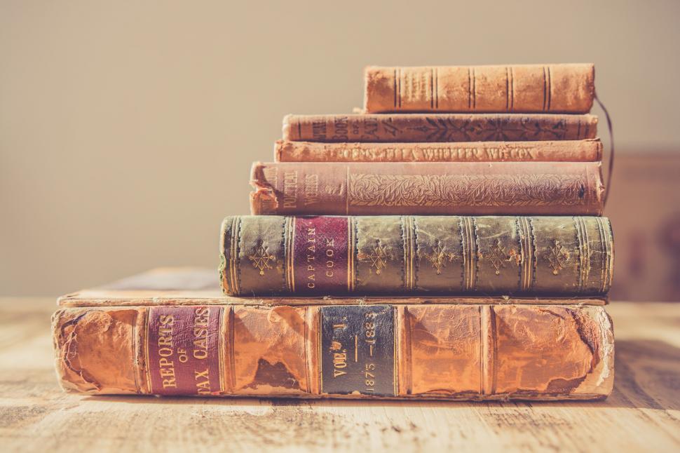 Free Image of Stack of Old Books on Wooden Table 
