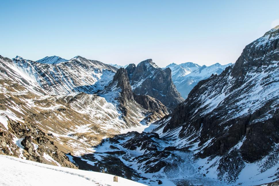 Free Image of Man Skiing Down Snow Covered Mountain 