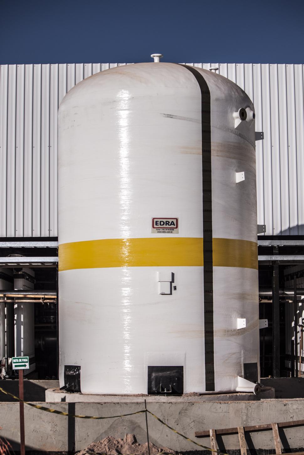 Free Image of Large White Tank in Front of Building 