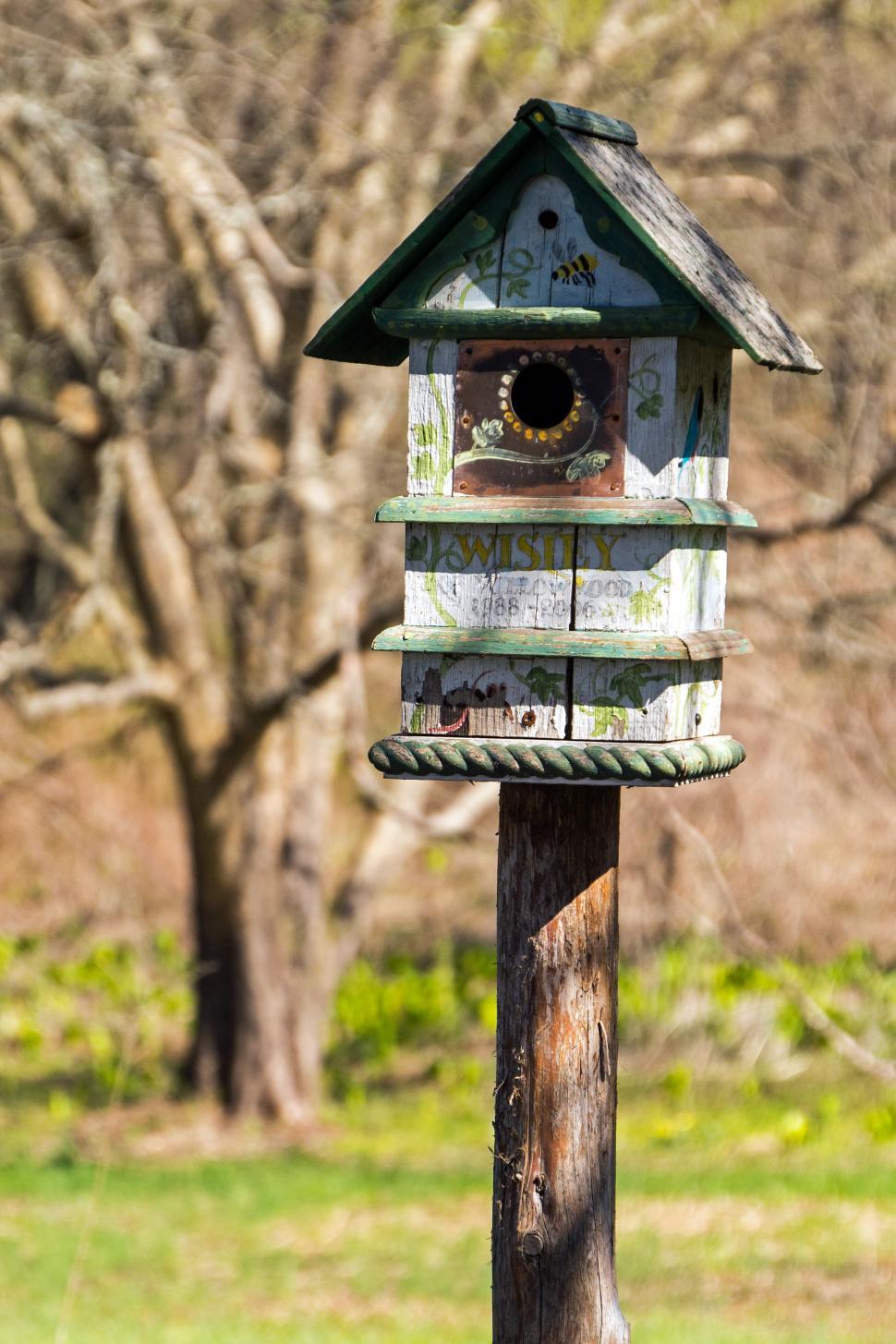 Free Image of Painted Birdhouse on a Post 