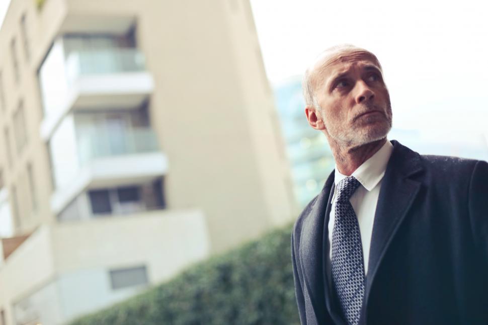 Free Image of Old Aged Man Standing Outside a Building 