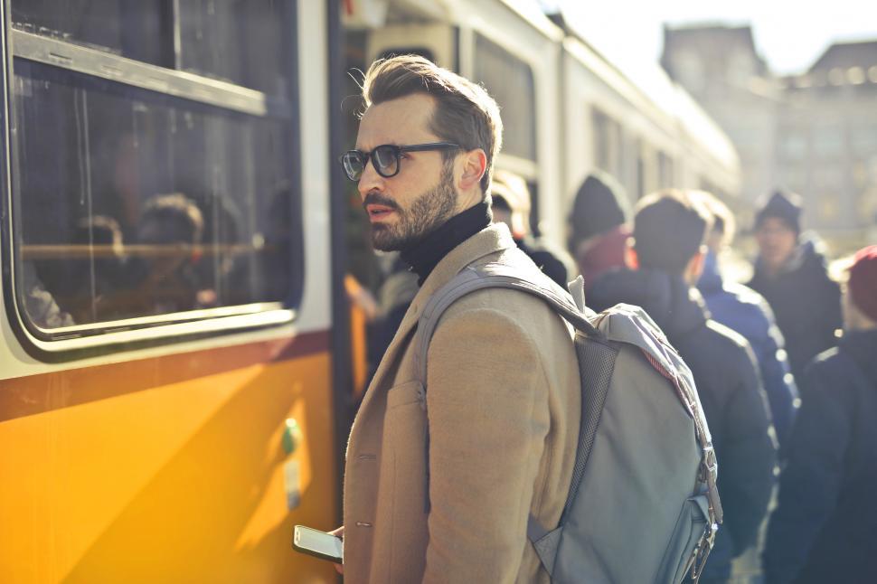 Free Image of Young Adult man in eyeglasses waiting for the train at tram stat 