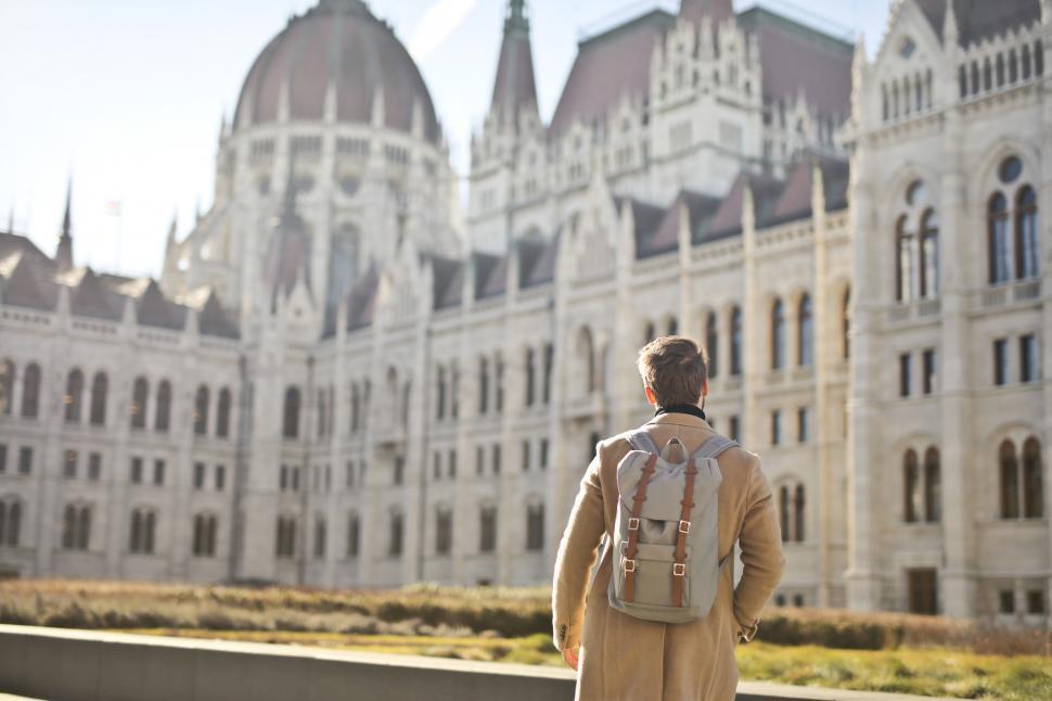 Free Image of Adult Man Looking on White Concrete Building 