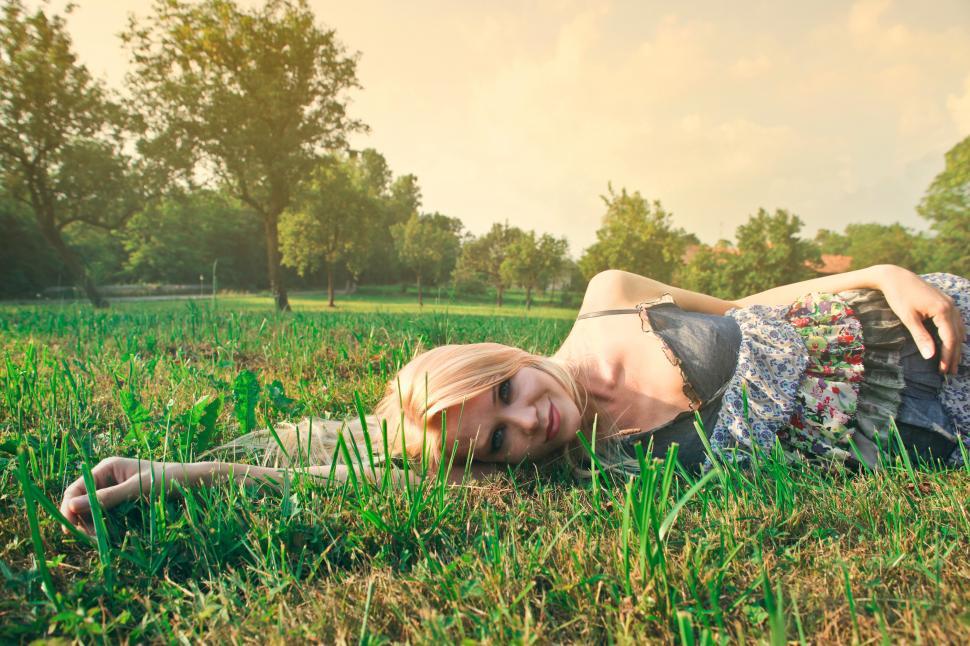 Free Image of Young Happy Woman Relaxing On Green Grass 