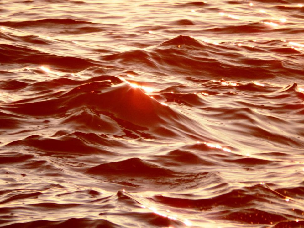 Free Image of Abstract background of golden patterns in ocean waves   