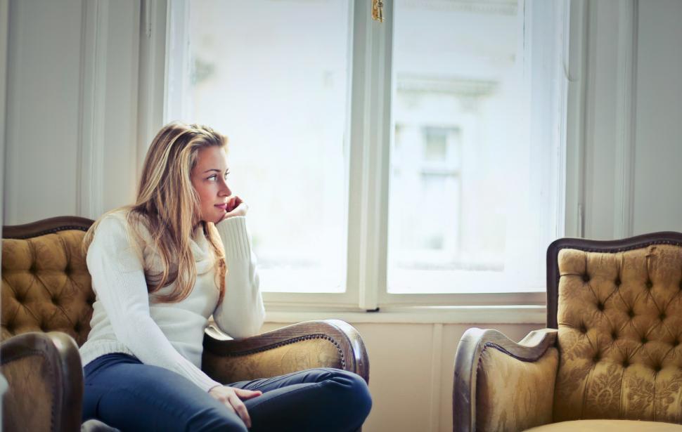 Free Image of Young Woman In Jeans And White Sweater Supporting Her Chin By Ha 