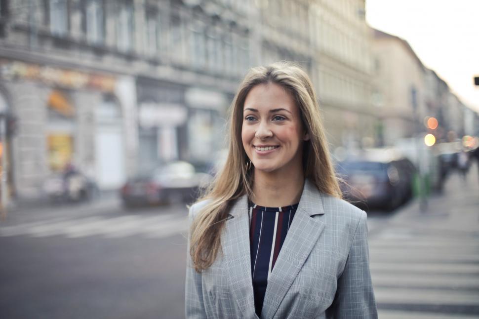 Free Image of Young Middle Aged Woman In Formal Blazer Walking on the street 
