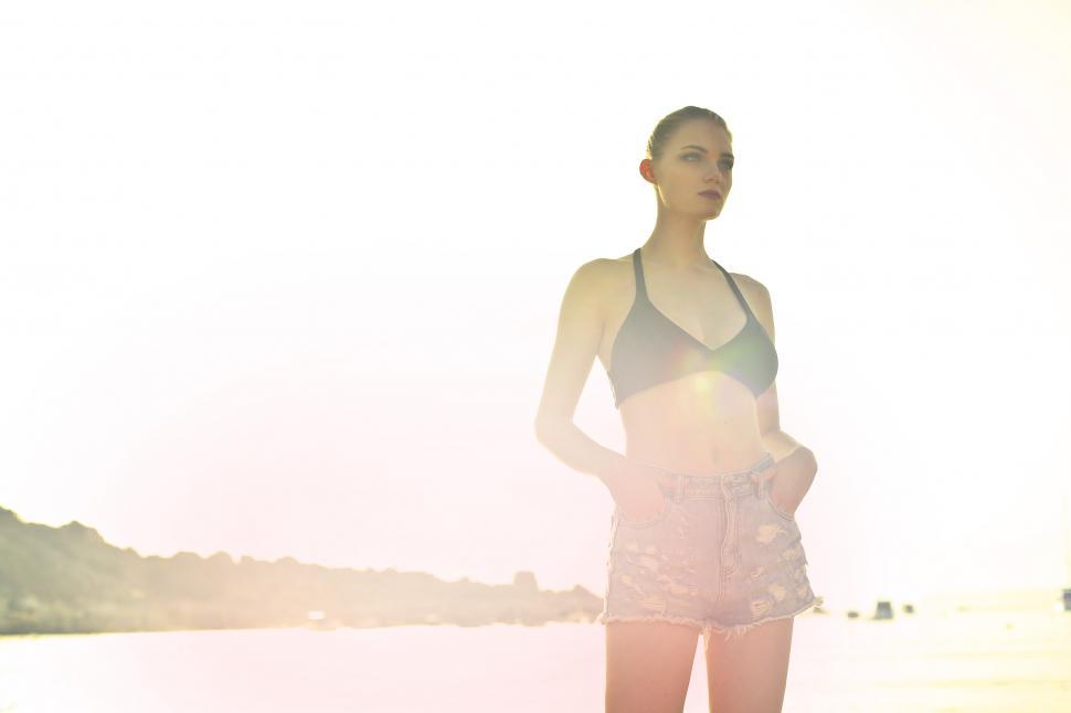 Free Image of Young Woman Posing In Black Bra And Jean Denim Shorts 