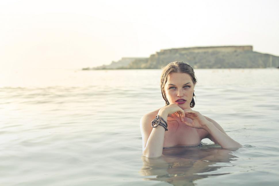 Free Image of Female Fashion Model Posing Semi Submerged In Sea 