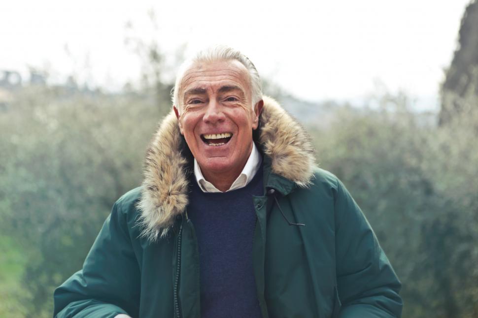 Free Image of Middle Aged Man Posing In Green Faux Fur Hooded Jacket 