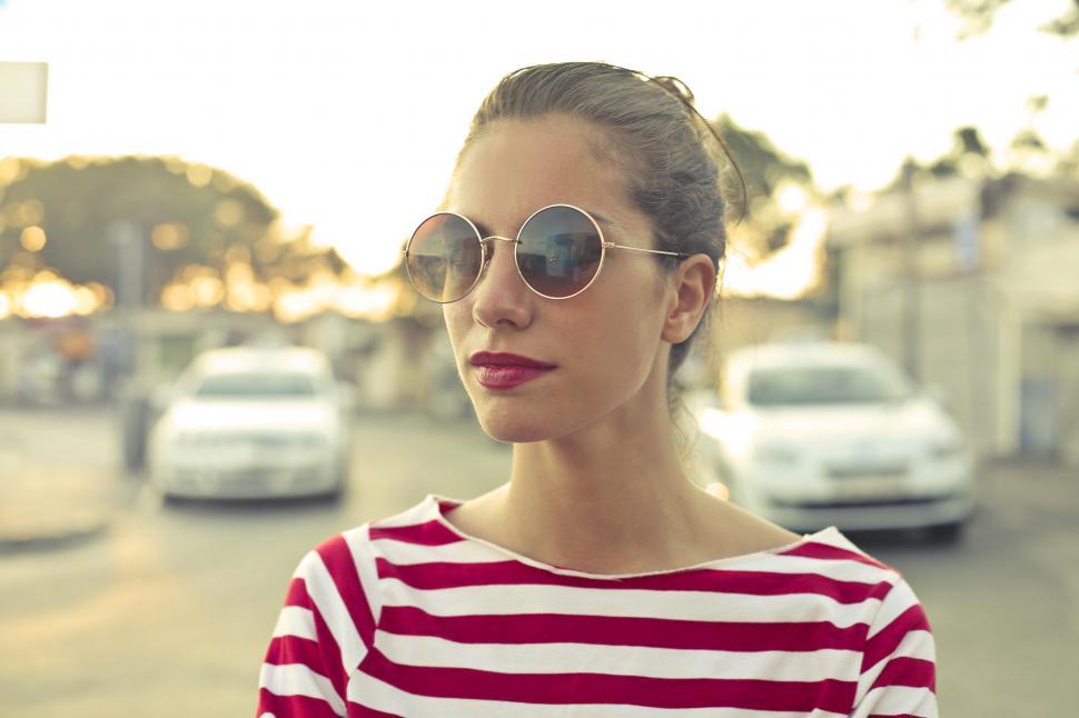 Free Image of Young Woman In Sunglasses And Red And White Striped T-Shirt 