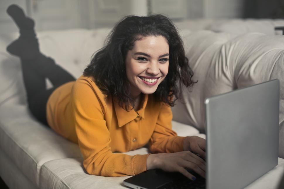 Free Image of A young woman wearing yellow button-up shirt top smiling while w 