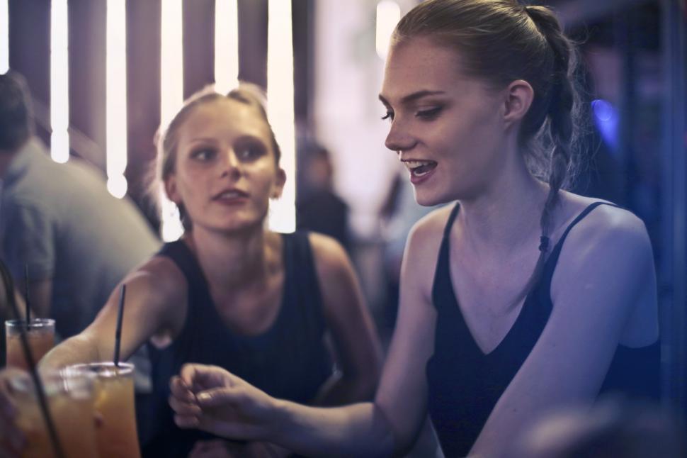 Free Image of Two young blonde women sitting in a bar 