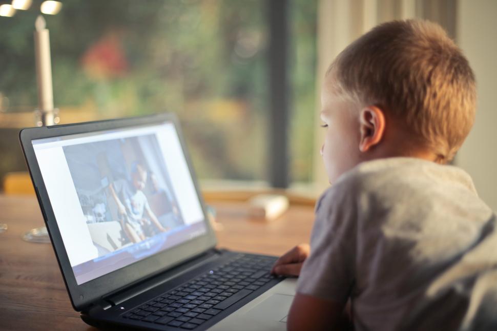 Free Image of A young caucasian child watching movie on laptop 