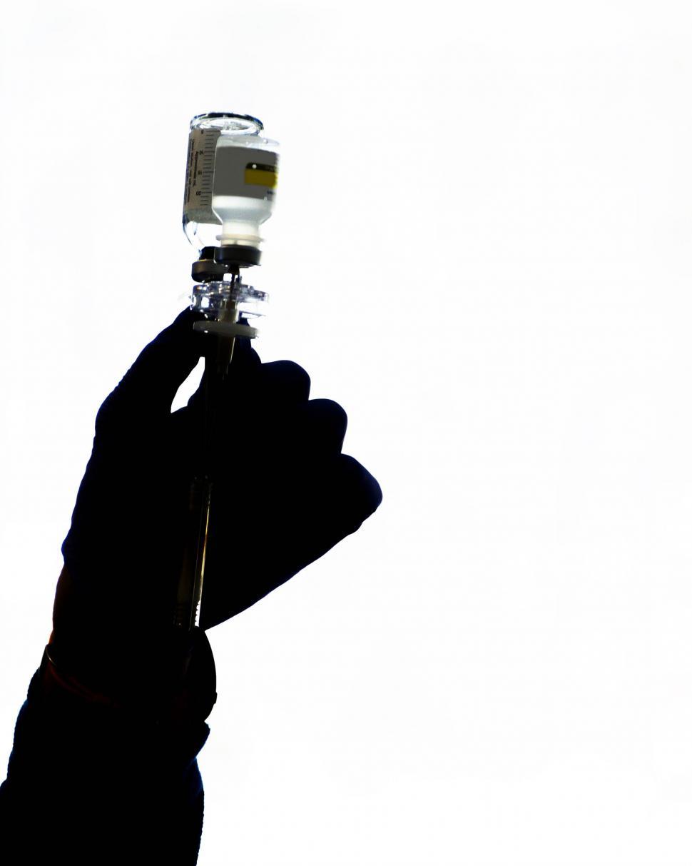 Free Image of Silhouette of hand with medical solution 