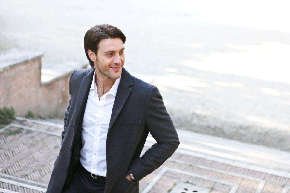 Free Image of A young caucasian man posing on a stairway 