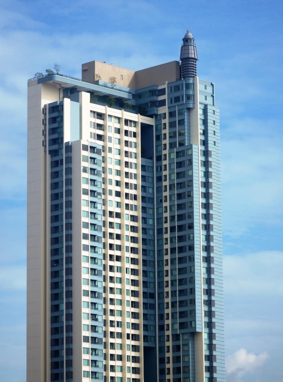 Free Image of Generic high-rise condominium building against a blue sky background  